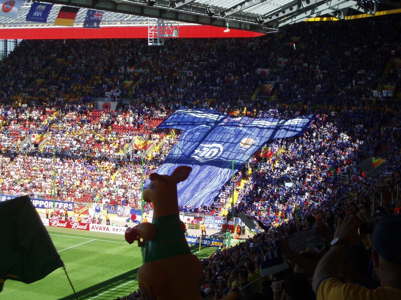 A giant Japan supporters' banner unfurled across a stadium stand